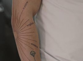 тату промені на лікті